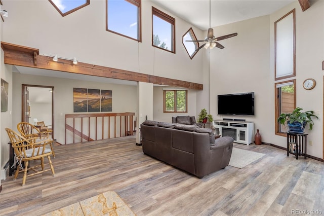 173 Silver Cloud Ln, Boulder, CO 80302 - living area featuring light wood-style floors, a towering ceiling, and ceiling fan