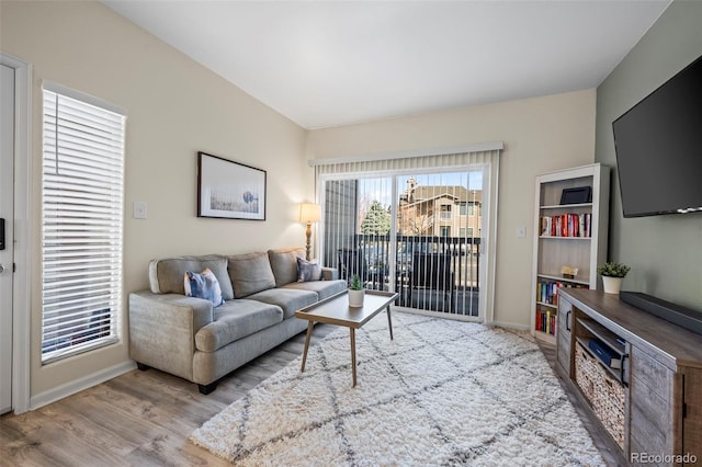 living room with baseboards and wood finished floors