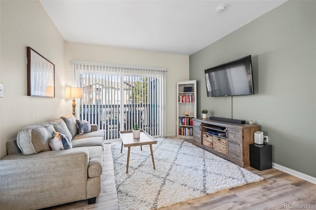 living room with baseboards and wood finished floors