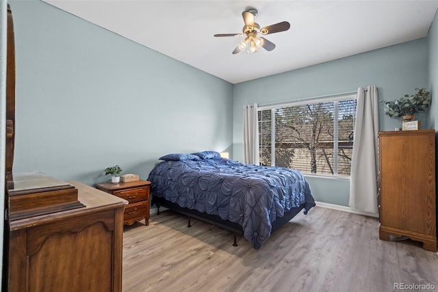 bedroom featuring light wood-style flooring, baseboards, and ceiling fan