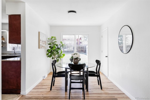 8651 Franklin St, Denver, CO 80229 - dining area featuring visible vents, light wood-type flooring, and baseboards