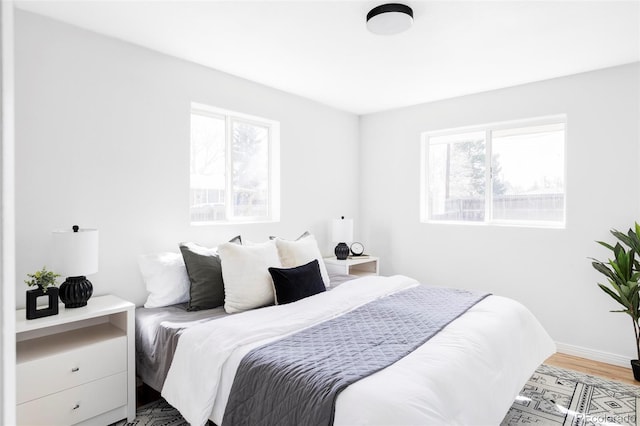 8651 Franklin St, Denver, CO 80229 - bedroom featuring wood finished floors, baseboards, and multiple windows