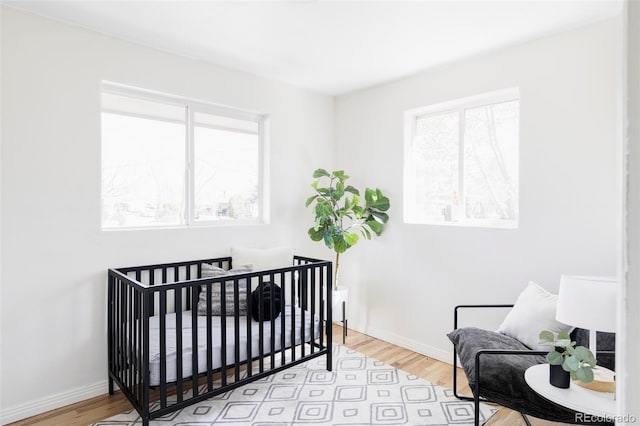 8651 Franklin St, Denver, CO 80229 - bedroom with wood finished floors, baseboards, and multiple windows