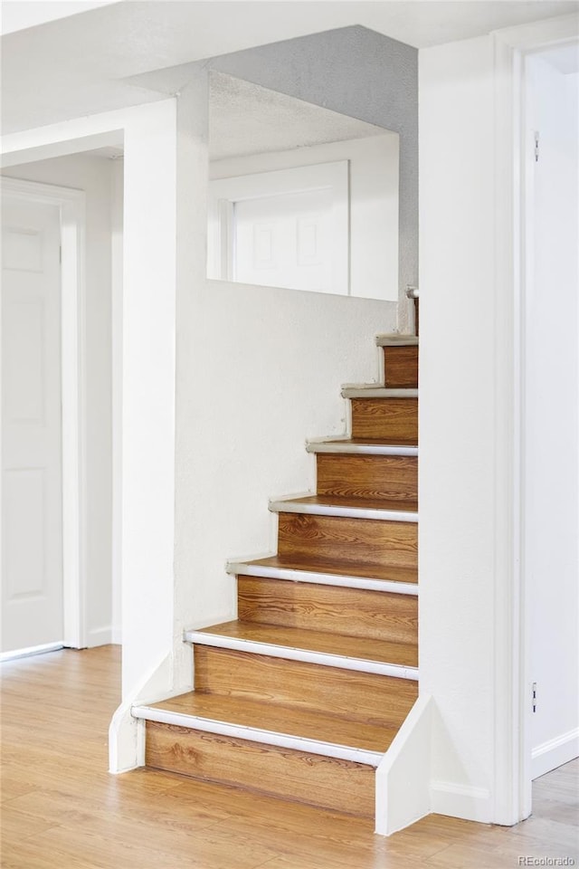 8651 Franklin St, Denver, CO 80229 - staircase featuring baseboards and wood finished floors