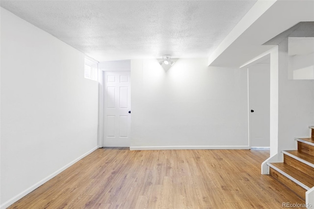 8651 Franklin St, Denver, CO 80229 - interior space featuring baseboards, stairs, light wood-style floors, and a textured ceiling