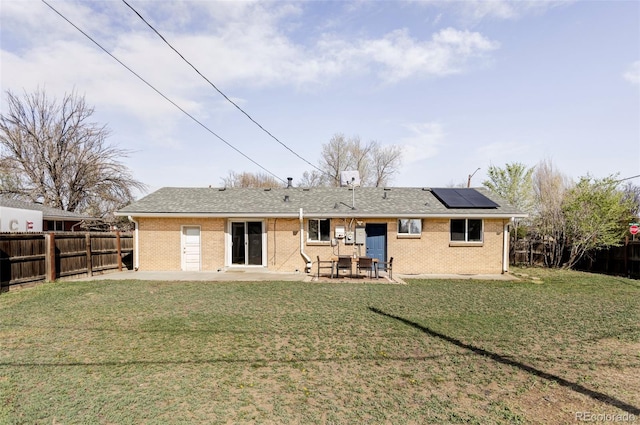 8651 Franklin St, Denver, CO 80229 - back of house with a patio area, a fenced backyard, a lawn, and roof mounted solar panels