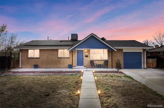 8651 Franklin St, Denver, CO 80229 - ranch-style home featuring fence, a front lawn, solar panels, an attached garage, and driveway