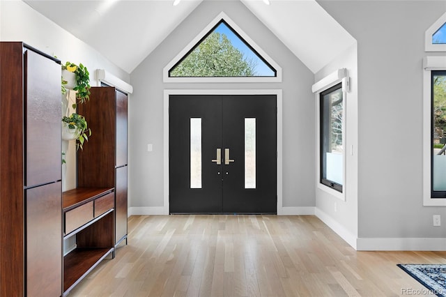 5859 E Ida Pl, Greenwood Village, CO 80111 - entryway featuring baseboards, light wood finished floors, and high vaulted ceiling