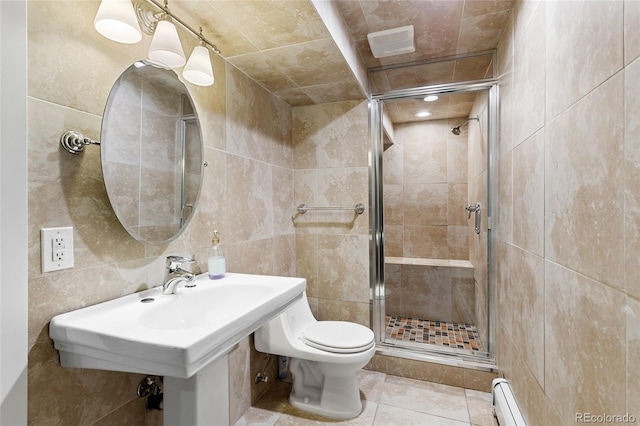 5859 E Ida Pl, Greenwood Village, CO 80111 - full bath featuring toilet, tile walls, tile patterned floors, a baseboard heating unit, and a shower stall