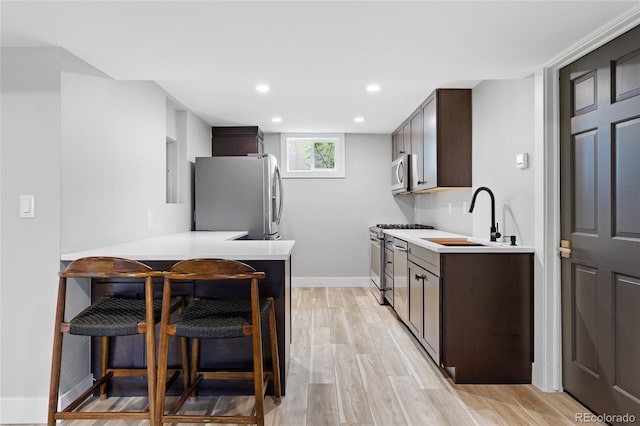 5859 E Ida Pl, Greenwood Village, CO 80111 - kitchen with light countertops, appliances with stainless steel finishes, and dark brown cabinets
