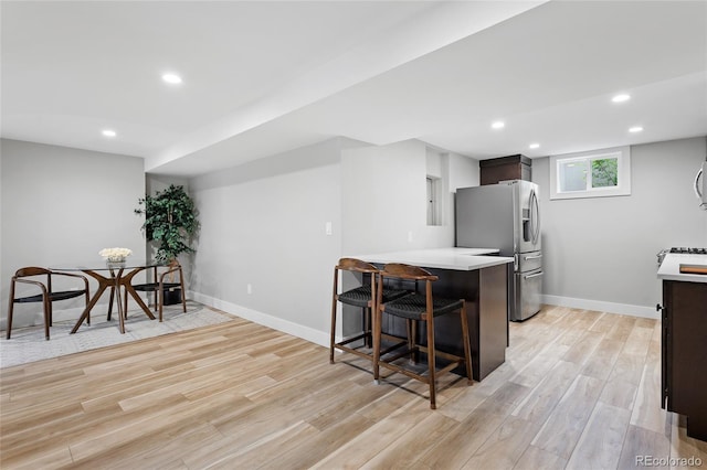 5859 E Ida Pl, Greenwood Village, CO 80111 - kitchen with a kitchen breakfast bar, light countertops, stainless steel fridge with ice dispenser, light wood finished floors, and a peninsula