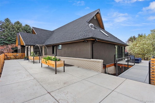 5859 E Ida Pl, Greenwood Village, CO 80111 - back of house featuring a patio area, roof with shingles, stucco siding, and fence