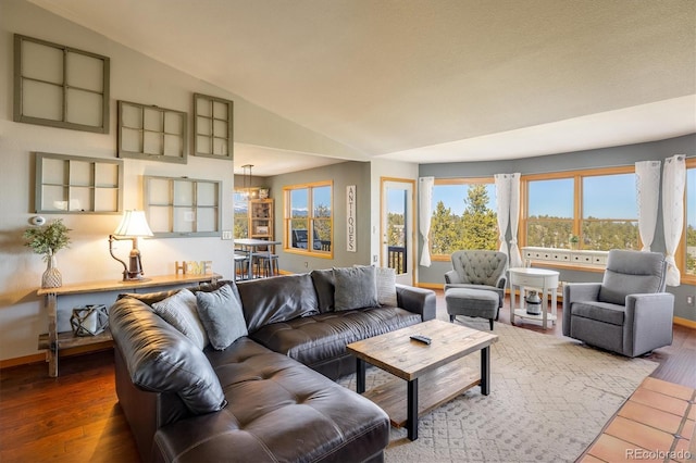 living room with hardwood / wood-style flooring and vaulted ceiling