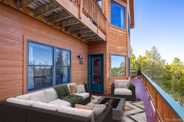 wooden terrace with an outdoor living space