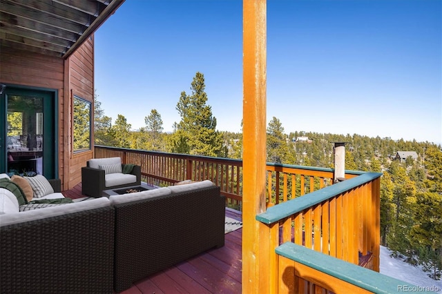 wooden deck with an outdoor living space