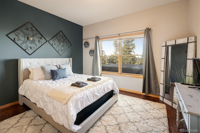 bedroom with dark hardwood / wood-style flooring