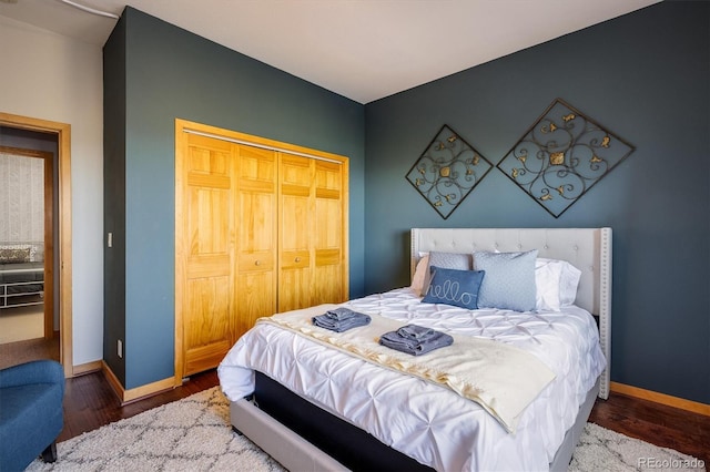 bedroom with dark hardwood / wood-style flooring and a closet