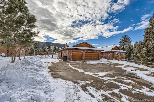 exterior space featuring a garage and a mountain view