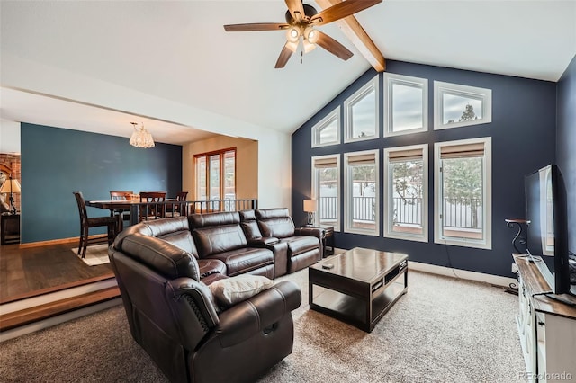 carpeted living room featuring ceiling fan and lofted ceiling with beams