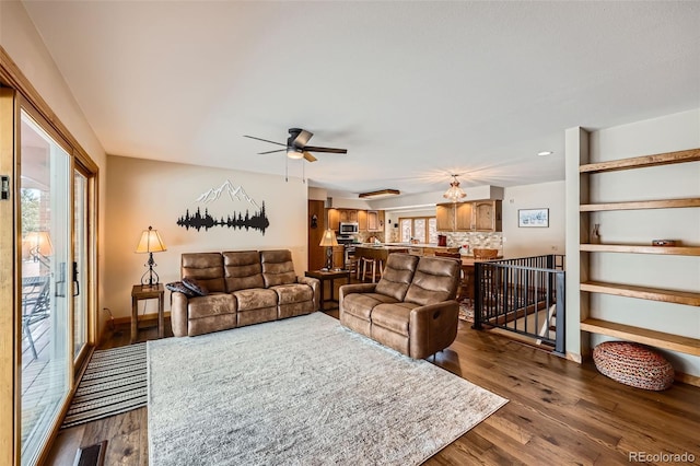 living room featuring dark hardwood / wood-style floors and ceiling fan