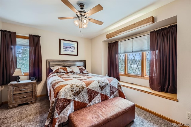 carpeted bedroom with multiple windows and ceiling fan