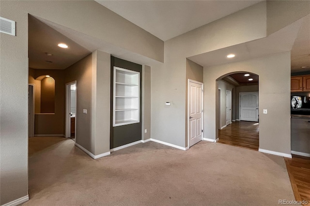 1430 Bluefield Ave, Longmont, CO 80504 - corridor featuring arched walkways, built in features, and baseboards