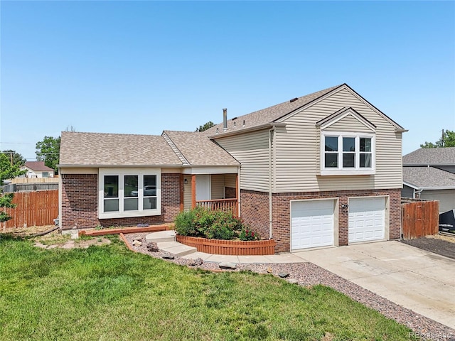1973 Bahama St, Aurora, CO 80011 - split level home featuring brick siding, an attached garage, driveway, and a shingled roof