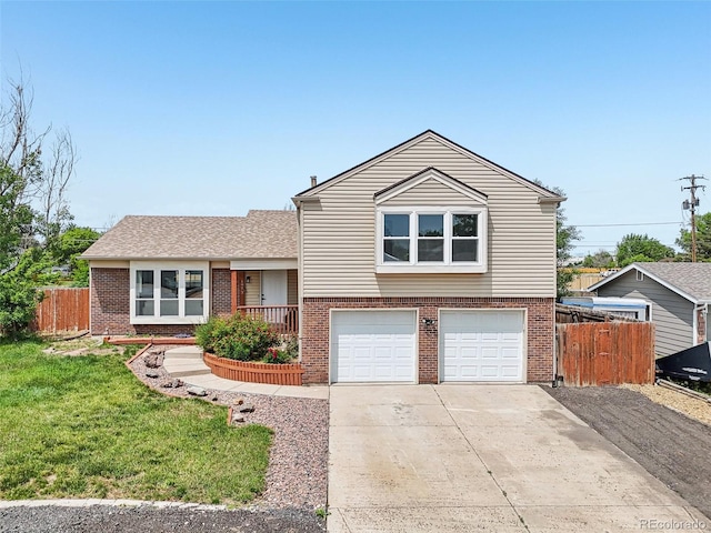 1973 Bahama St, Aurora, CO 80011 - tri-level home featuring brick siding, an attached garage, and driveway