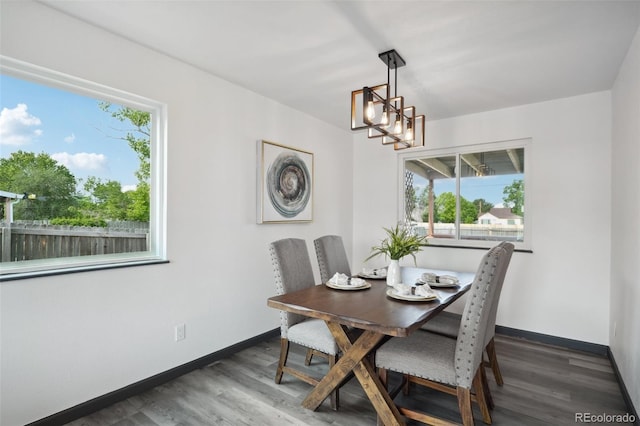 1973 Bahama St, Aurora, CO 80011 - dining space with wood finished floors, a chandelier, and baseboards