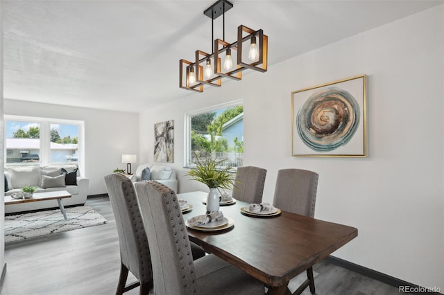 1973 Bahama St, Aurora, CO 80011 - dining room featuring a chandelier, healthy amount of natural light, wood finished floors, and baseboards