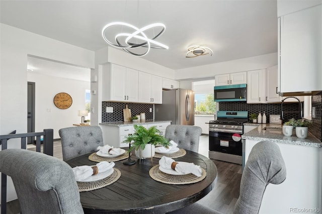 1973 Bahama St, Aurora, CO 80011 - dining space featuring a chandelier and dark wood-type flooring