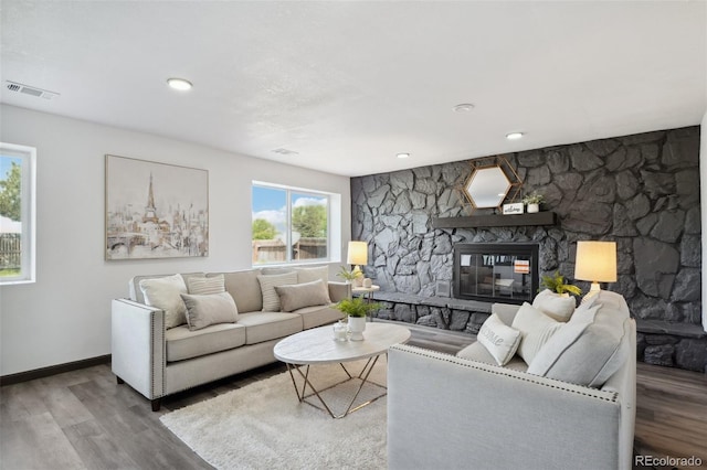 1973 Bahama St, Aurora, CO 80011 - living room with wood finished floors, a stone fireplace, and baseboards