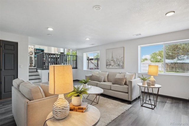 1973 Bahama St, Aurora, CO 80011 - living area with wood finished floors, stairway, baseboards, and recessed lighting