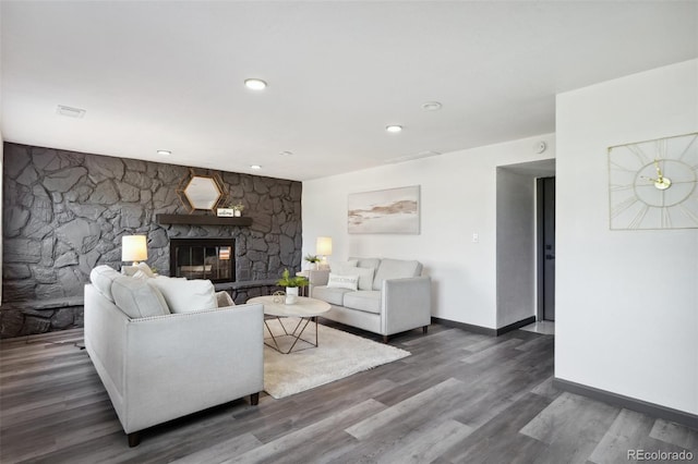 1973 Bahama St, Aurora, CO 80011 - living room with a stone fireplace, wood finished floors, baseboards, and recessed lighting