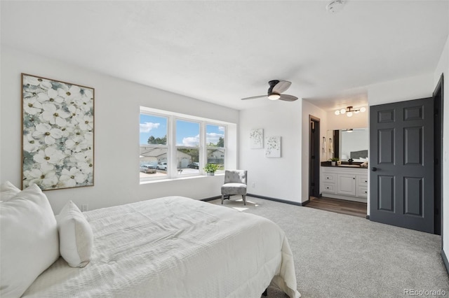1973 Bahama St, Aurora, CO 80011 - bedroom featuring dark carpet, ensuite bathroom, baseboards, and ceiling fan