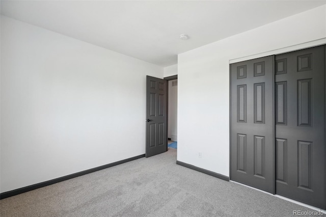 1973 Bahama St, Aurora, CO 80011 - unfurnished bedroom featuring light colored carpet, baseboards, and a closet
