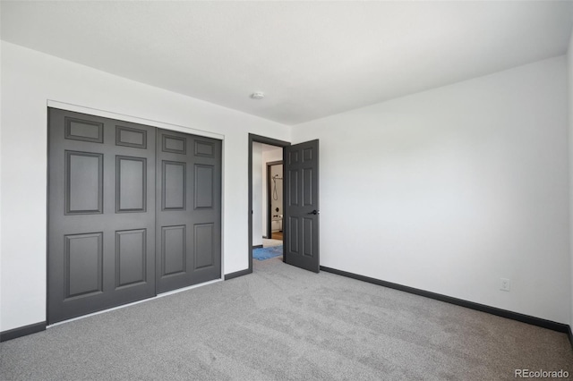 1973 Bahama St, Aurora, CO 80011 - unfurnished bedroom featuring light colored carpet, baseboards, and a closet