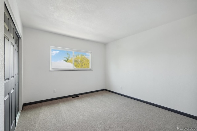 1973 Bahama St, Aurora, CO 80011 - unfurnished bedroom featuring carpet, a closet, and baseboards