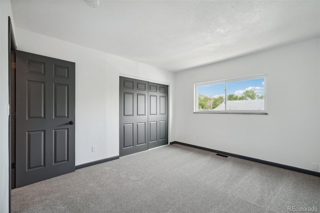 1973 Bahama St, Aurora, CO 80011 - unfurnished bedroom featuring carpet floors, baseboards, and a closet