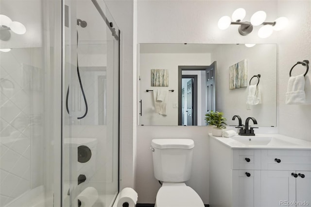 1973 Bahama St, Aurora, CO 80011 - bathroom with vanity, a stall shower, and toilet