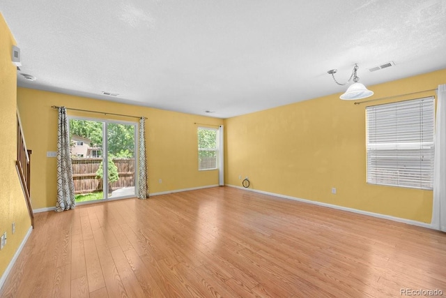 426 Plowman Way, Fort Collins, CO 80526 - unfurnished room with light wood-style floors and a textured ceiling