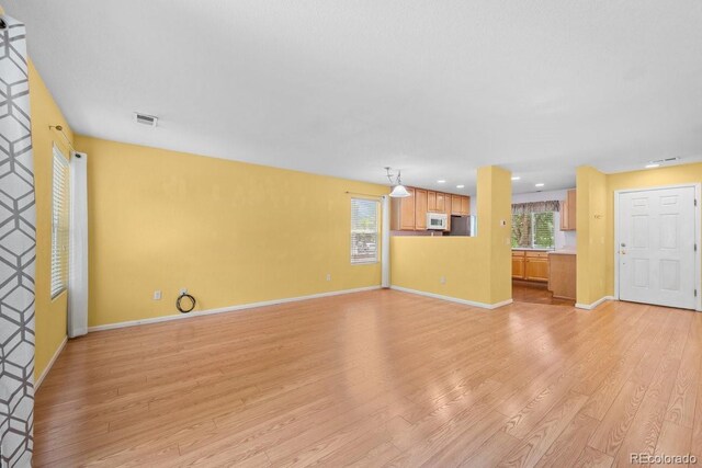 426 Plowman Way, Fort Collins, CO 80526 - unfurnished living room featuring light wood-type flooring, healthy amount of natural light, and recessed lighting