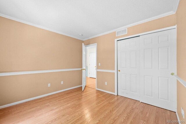 426 Plowman Way, Fort Collins, CO 80526 - unfurnished bedroom featuring light wood-style flooring, ornamental molding, and a closet