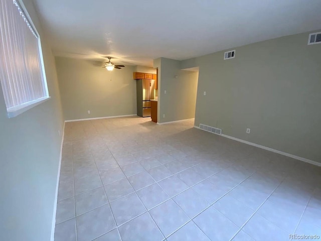 100 E Highline Cir Unit 105, Centennial, CO 80122 - spare room featuring light tile patterned floors, ceiling fan, and baseboards