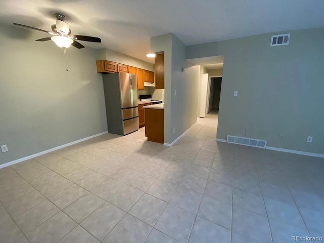 100 E Highline Cir Unit 105, Centennial, CO 80122 - kitchen with freestanding refrigerator, a ceiling fan, brown cabinetry, light countertops, and light tile patterned floors