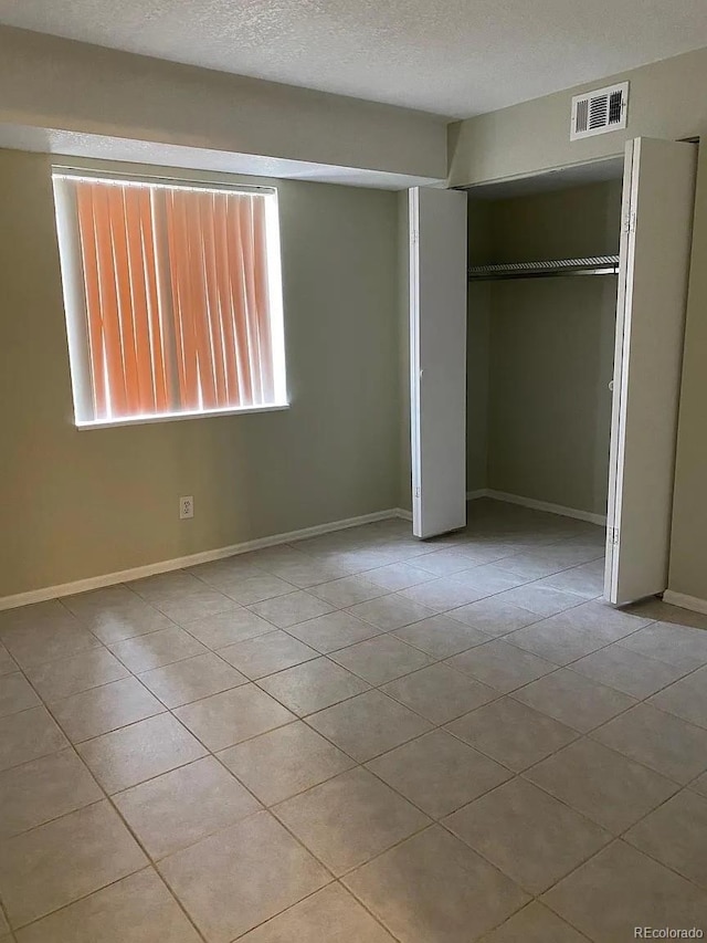 100 E Highline Cir Unit 105, Centennial, CO 80122 - unfurnished bedroom with tile patterned flooring, a closet, and baseboards