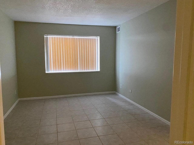 100 E Highline Cir Unit 105, Centennial, CO 80122 - unfurnished room with tile patterned flooring, a textured ceiling, and baseboards