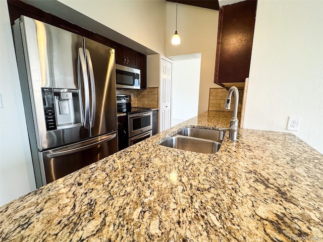 6640 S Heritage Pl W, Centennial, CO 80111 - kitchen featuring a sink, backsplash, light stone countertops, and stainless steel appliances