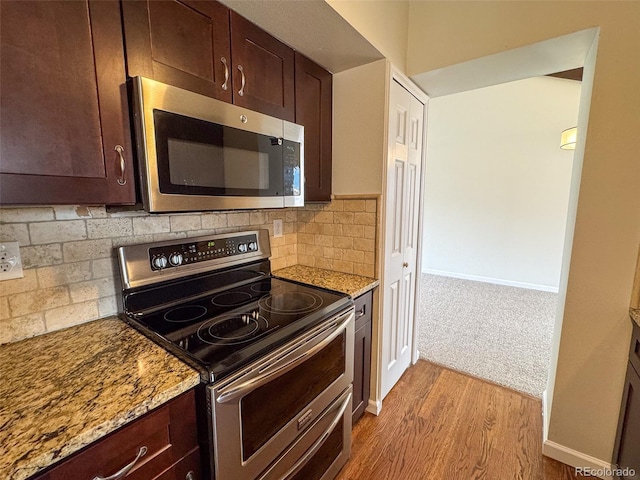6640 S Heritage Pl W, Centennial, CO 80111 - kitchen with appliances with stainless steel finishes, wood finished floors, light stone counters, and dark brown cabinets
