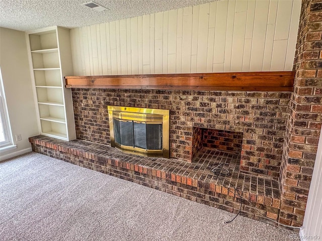6640 S Heritage Pl W, Centennial, CO 80111 - interior details featuring built in features, visible vents, carpet, a textured ceiling, and a fireplace